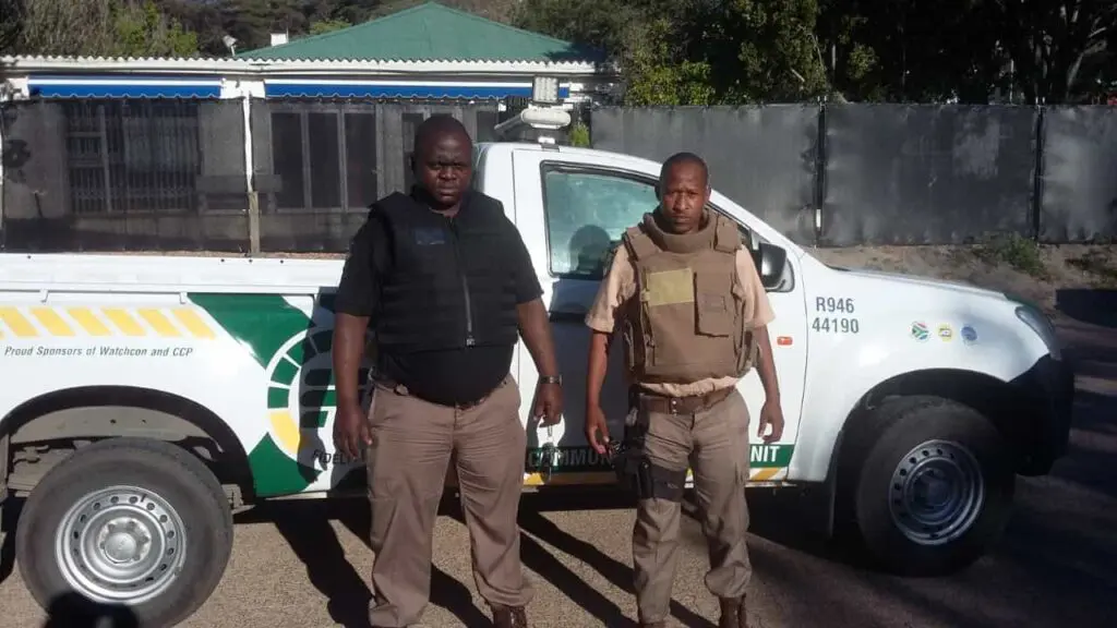 Two guards in front of security van