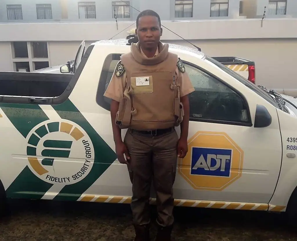 ADT Security guard in front of car