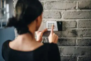 woman activating her security system alarm