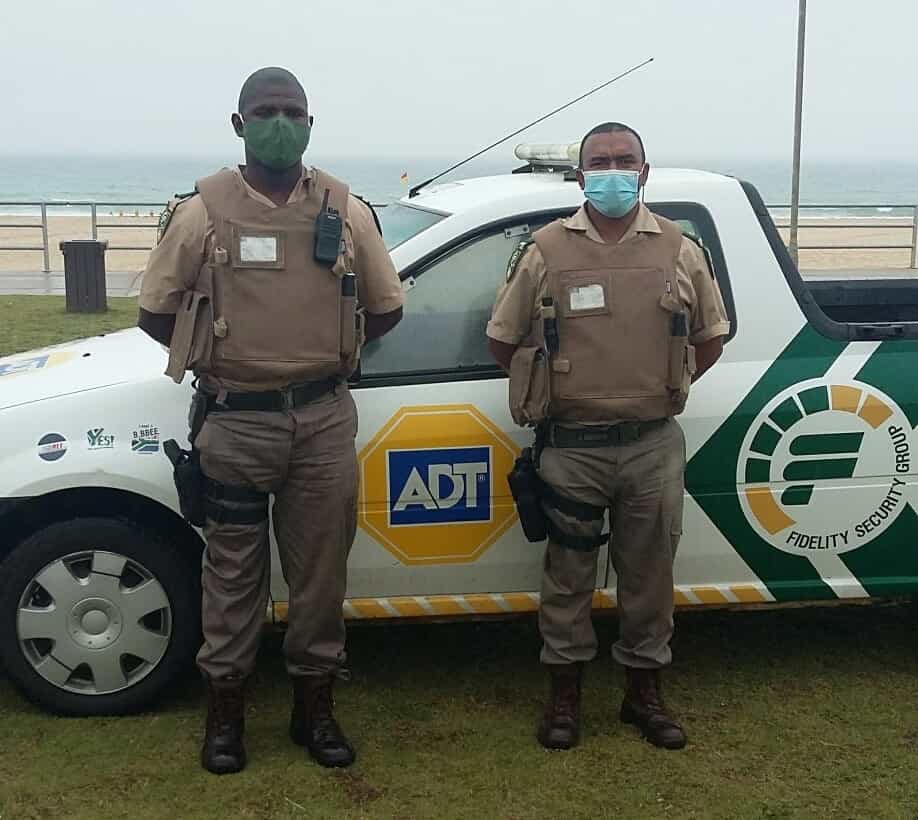 Two ADT Fidelity guards in front of security car