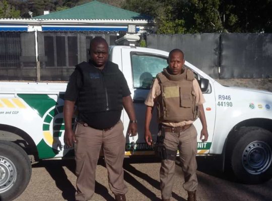 Two guards in front of security van