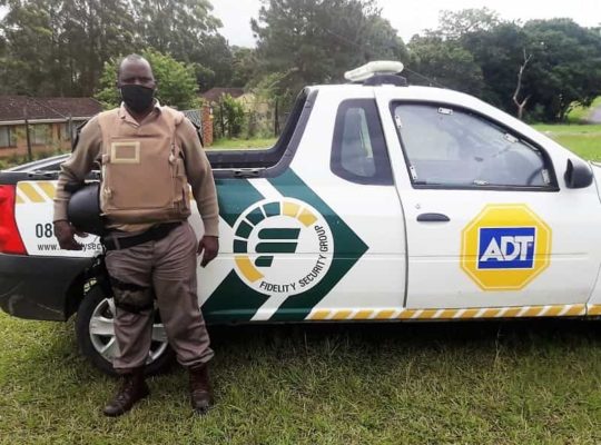 ADT security guard next to response vehicle