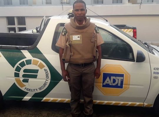 ADT Security guard in front of car