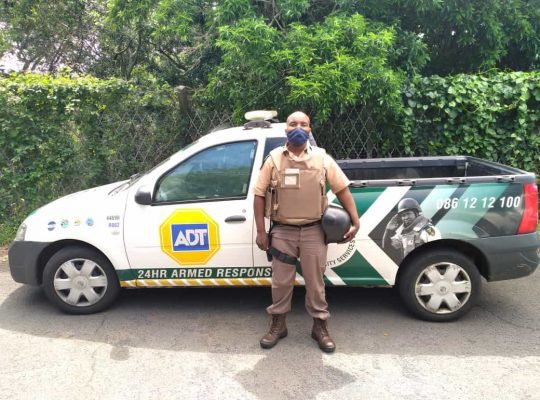 ADT secuirty guard next to armed response vehicle