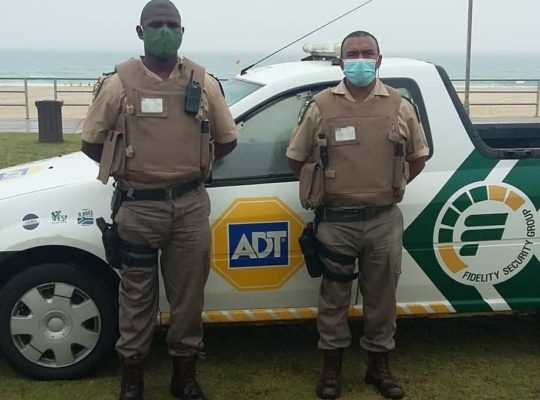 Two ADT Fidelity guards in front of security car