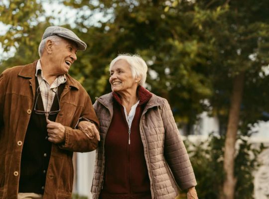 elderly couple smiling at each other